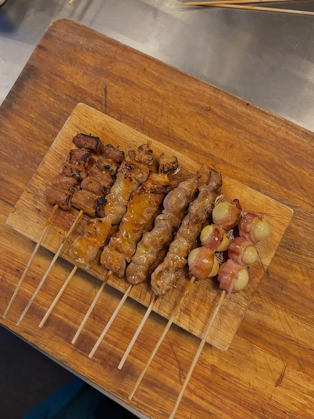 Freshly grilled yakitori skewers on a metal tray