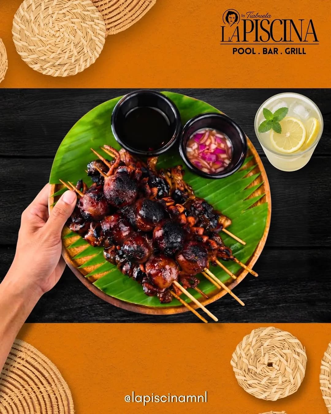 A platter of grilled pork skewers with dipping sauces