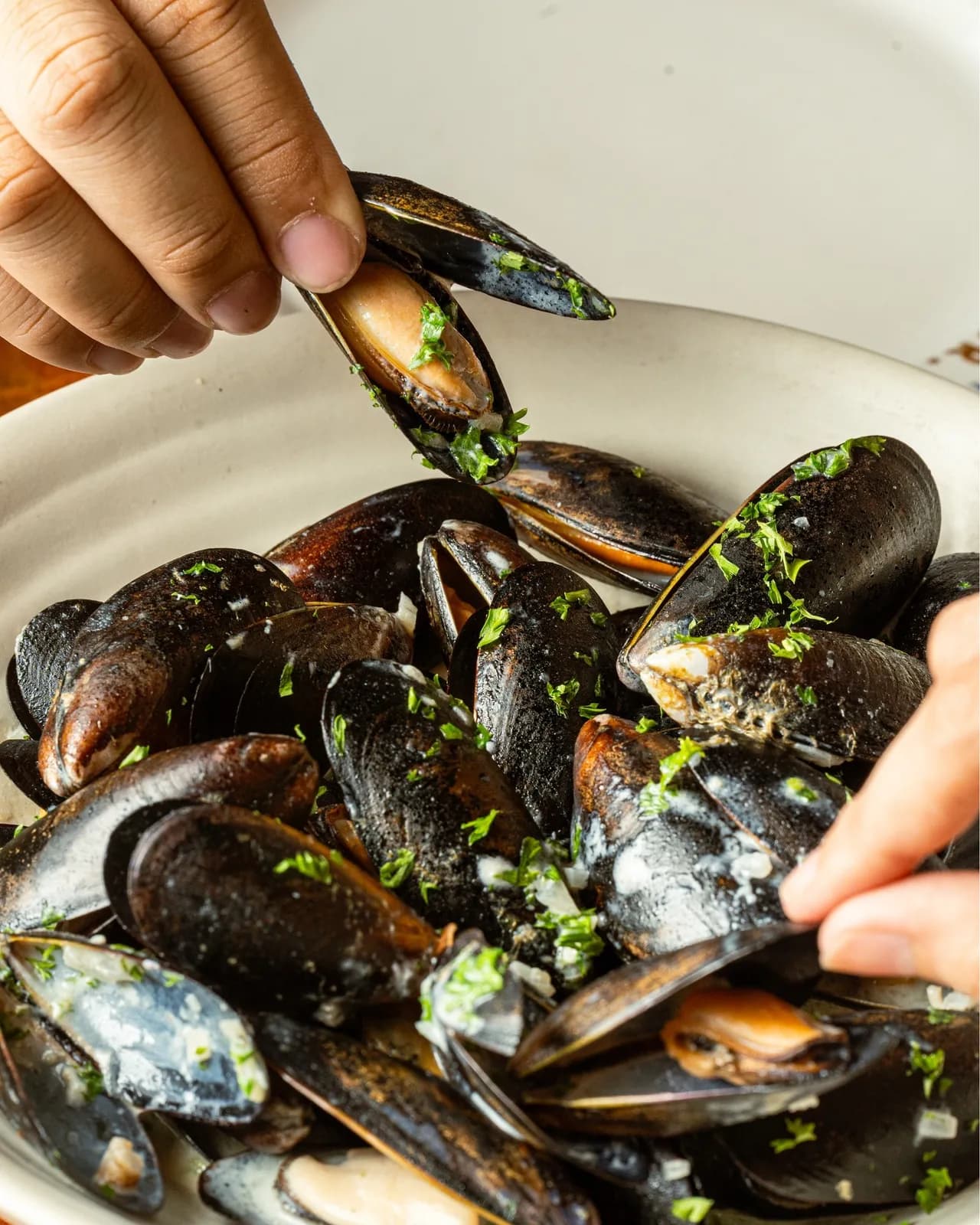 Bowl of mussels with herbs ready to eat