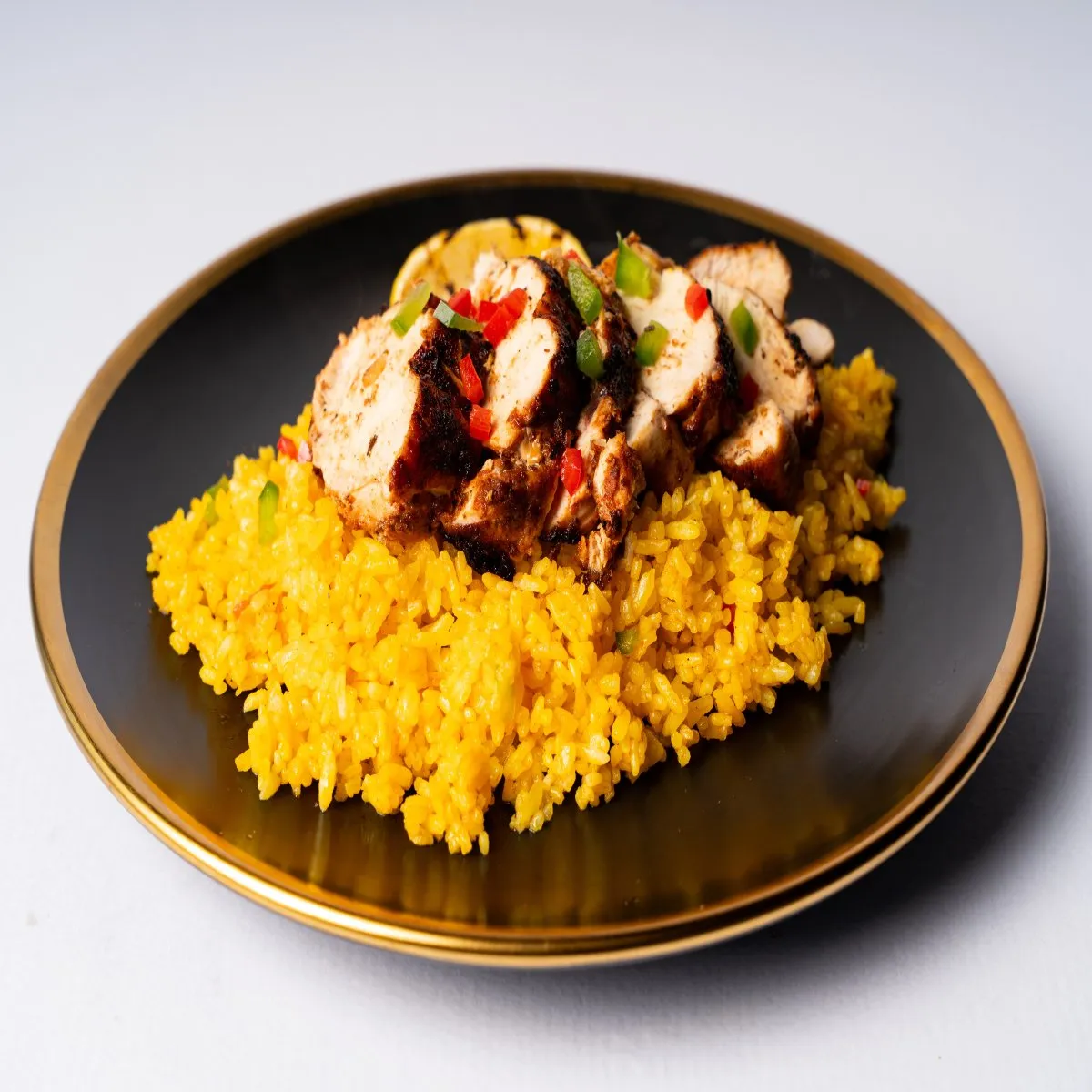 Blackened Cajun chicken breast served over Mexican rice with vegetables.