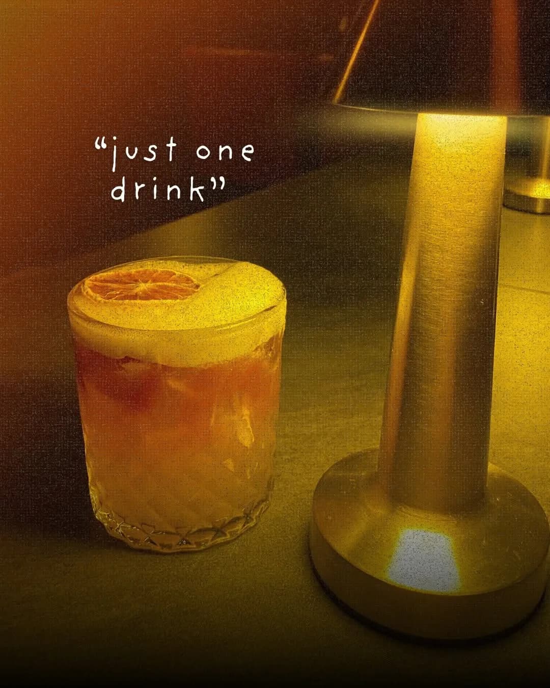 Two colorful cocktails beside a small table lamp