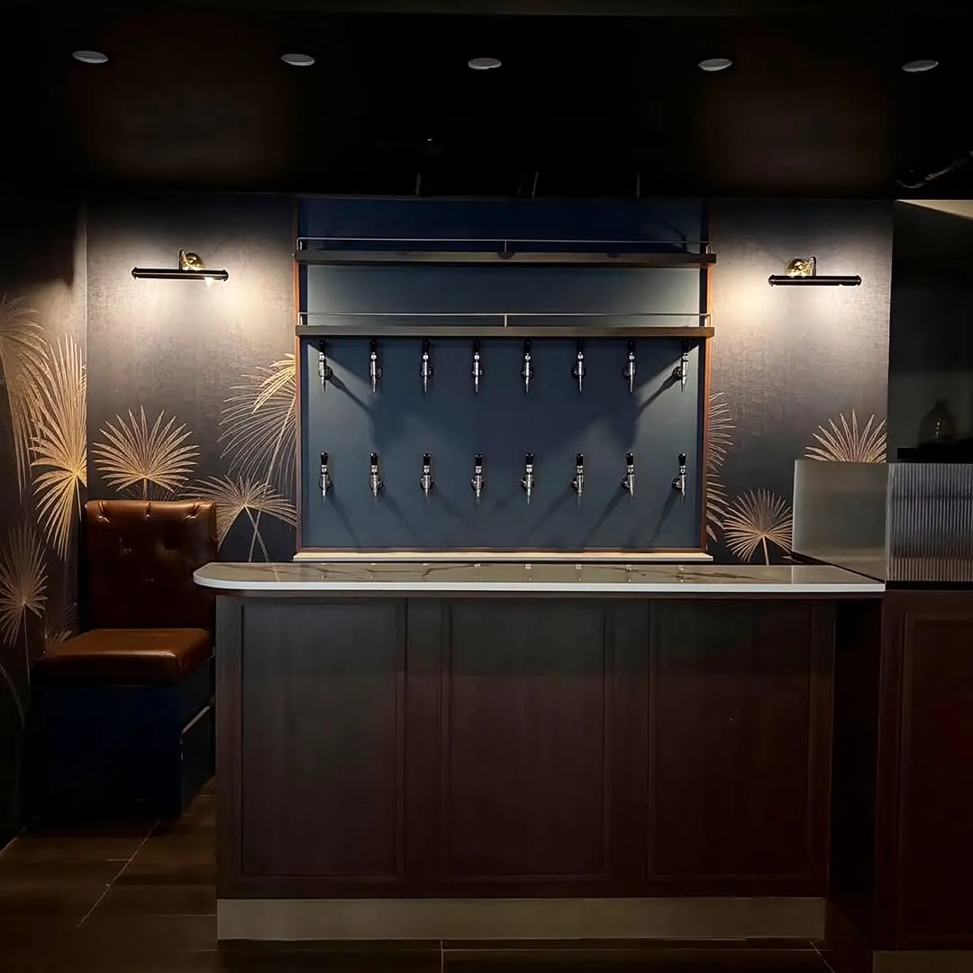 Renovated cocktail bar with a dark counter and warm wall lights