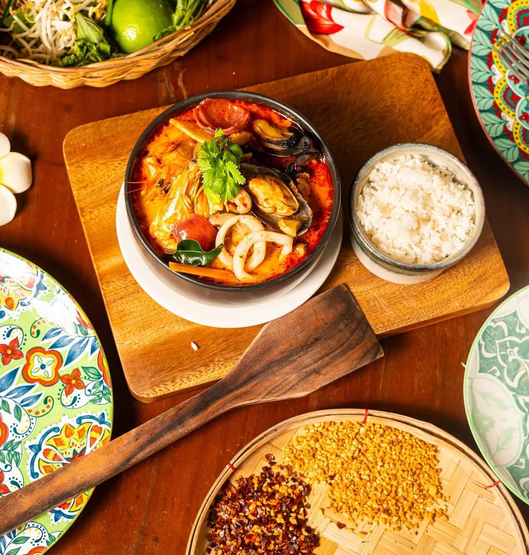 Bowl of spicy seafood Tom Yum soup with rice