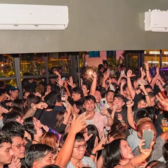 Wide view of a crowded night inside Sanctuary