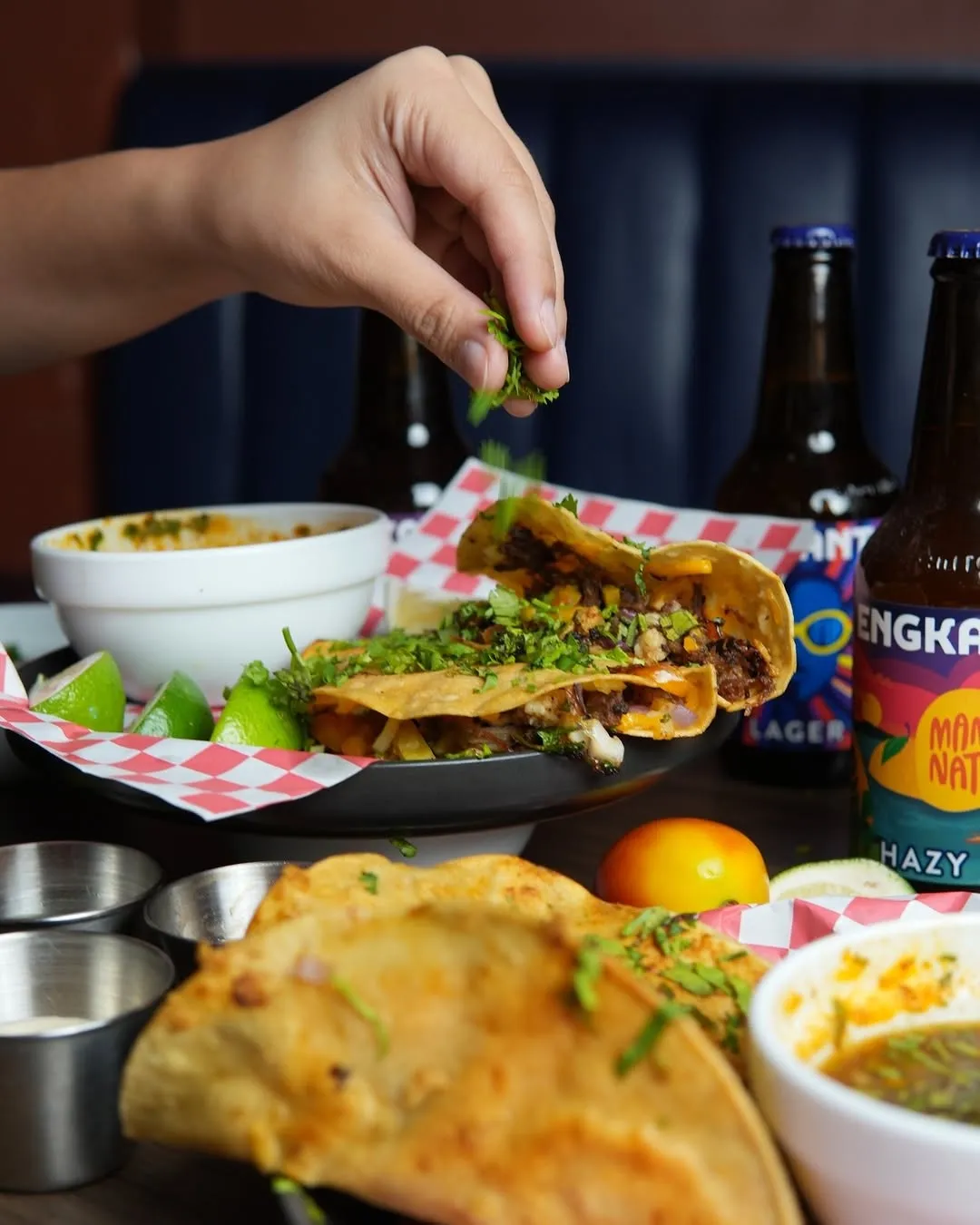 Beef birria taco being dipped into consommé