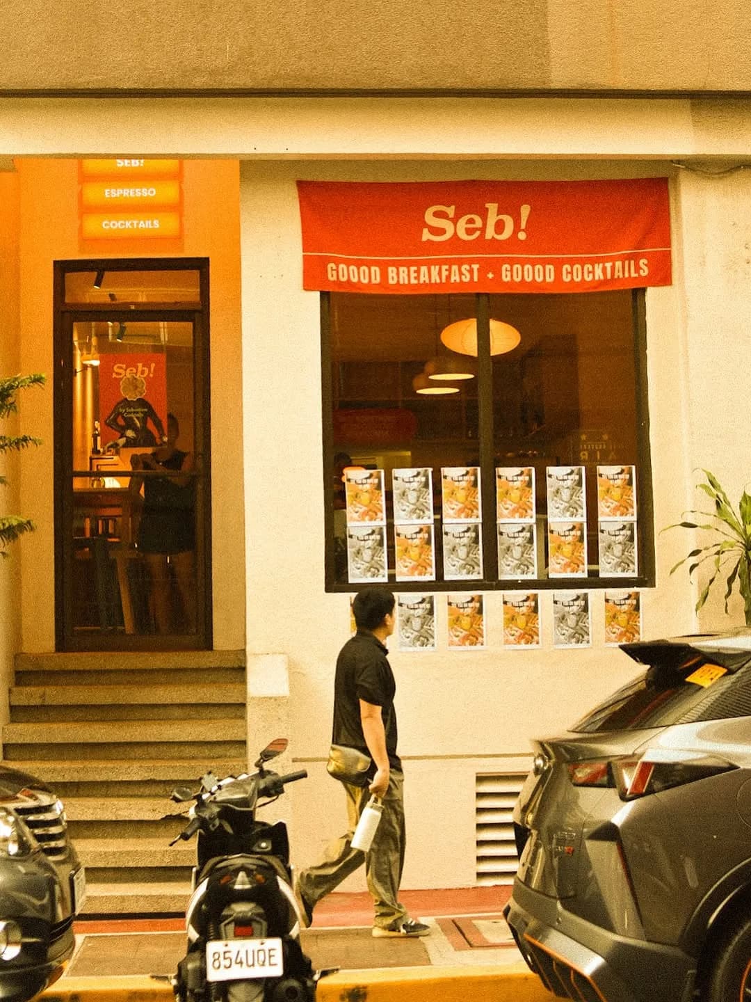 Warmly lit Seb entrance and menu wall after dark
