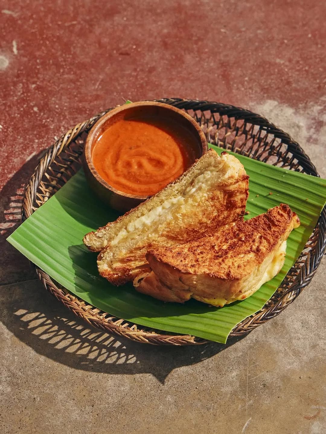 Kesong puti grilled cheese on milk bread with a bowl of tomato soup