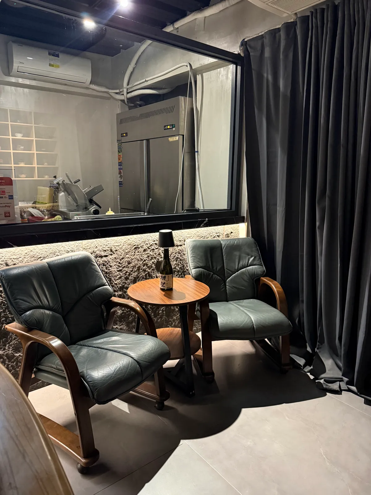 Two lounge chairs and a small table in the matcha bar