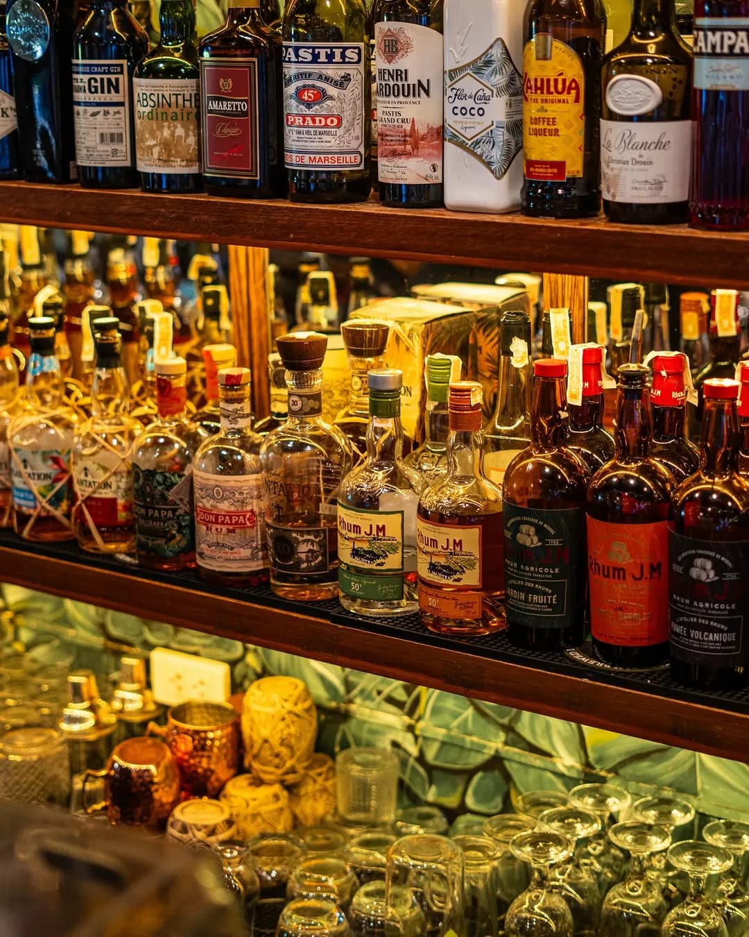 Bottles and cocktail ingredients behind the illuminated bar