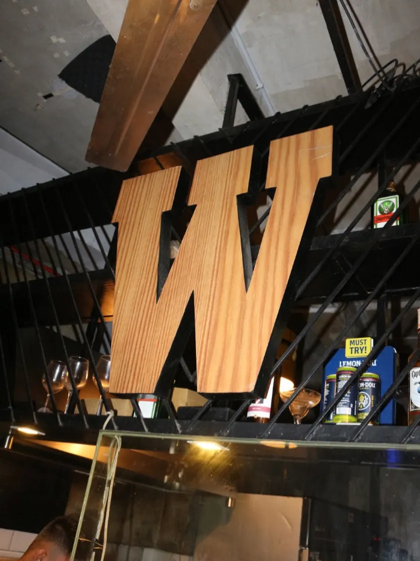 Wicked Dogs bar interior with a large wooden W above the counter