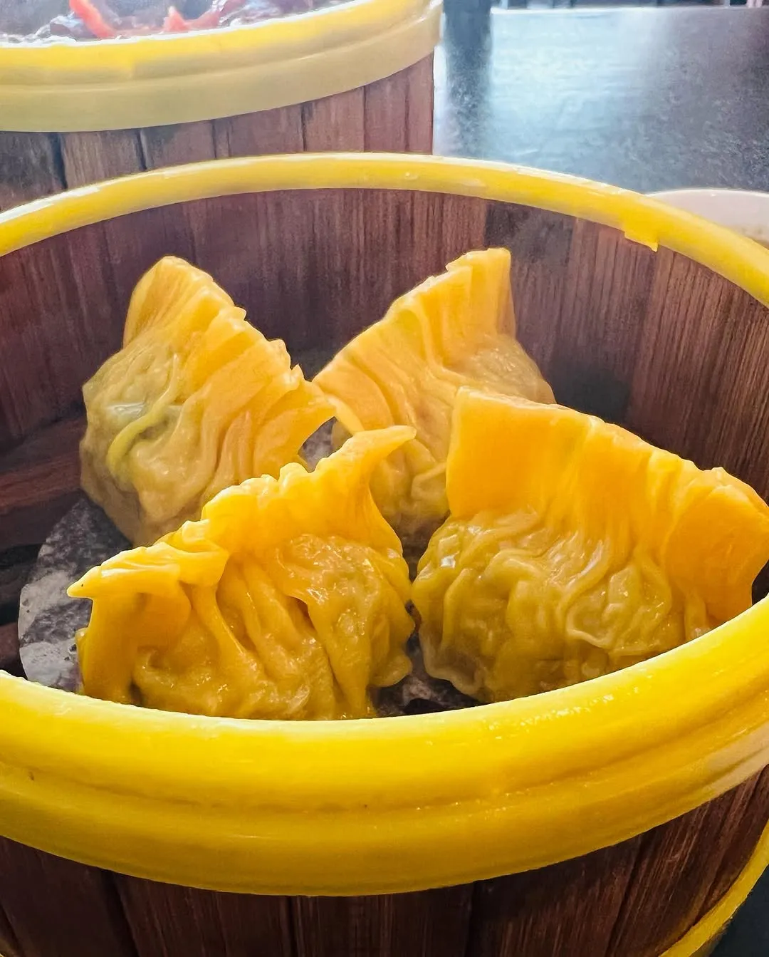 Basket of golden steamed and fried dumplings