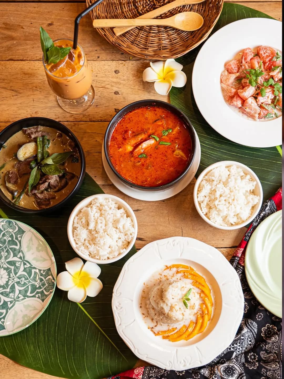 Shared table spread of Thai dishes and rice