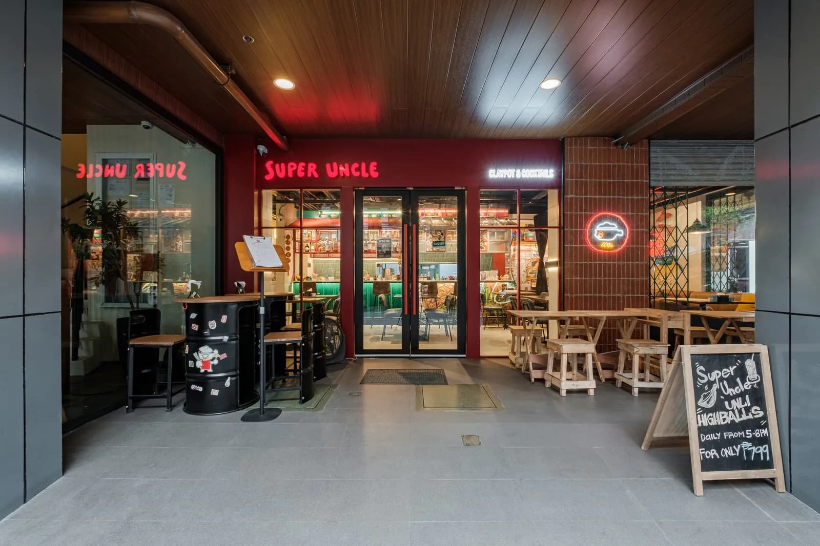 Super Uncle storefront with outdoor tables and red signage