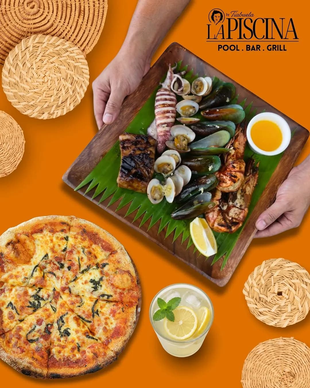 Pizza, grilled seafood and drinks arranged on a table