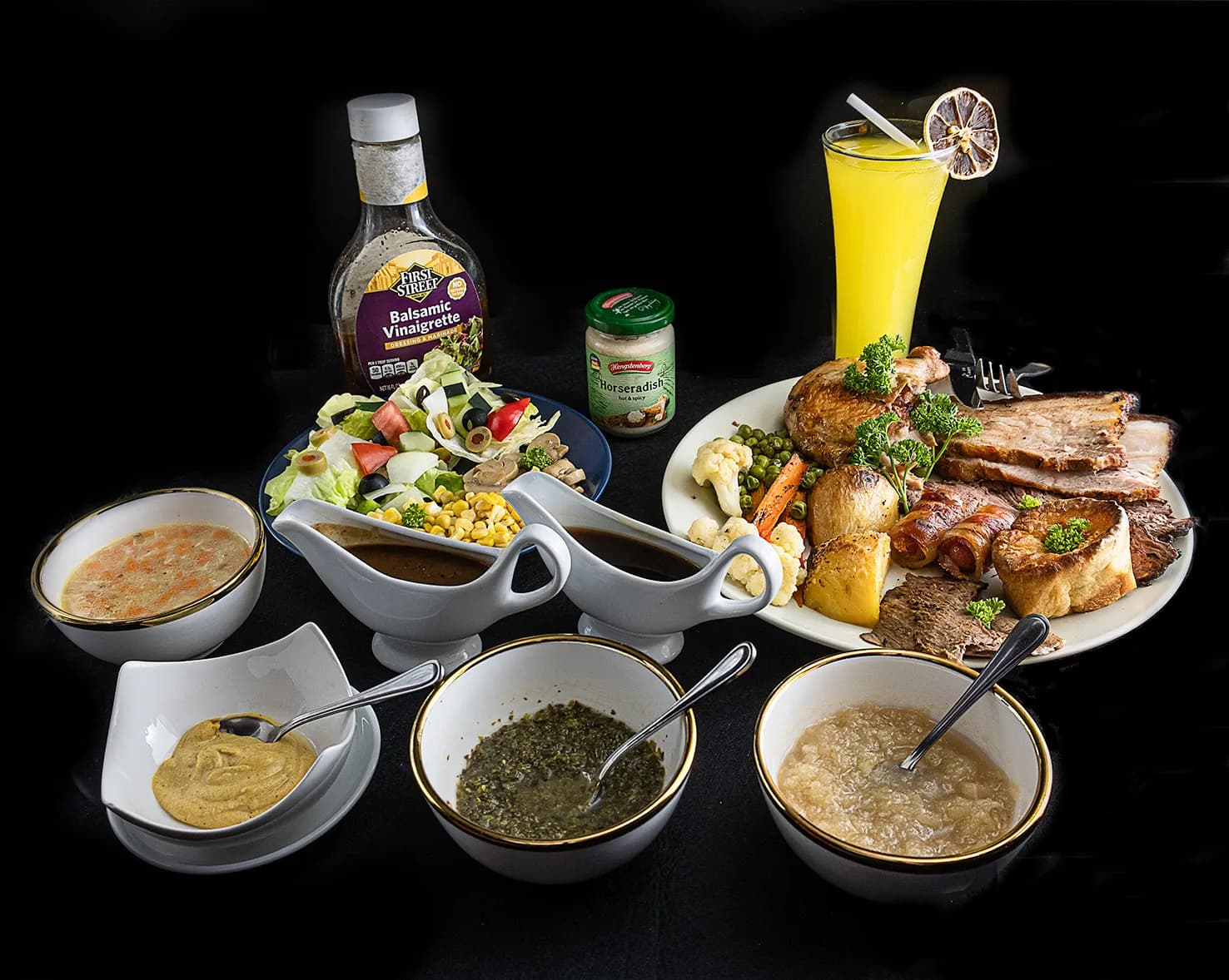 Roast meats, vegetables, salad and sauces arranged for a meal