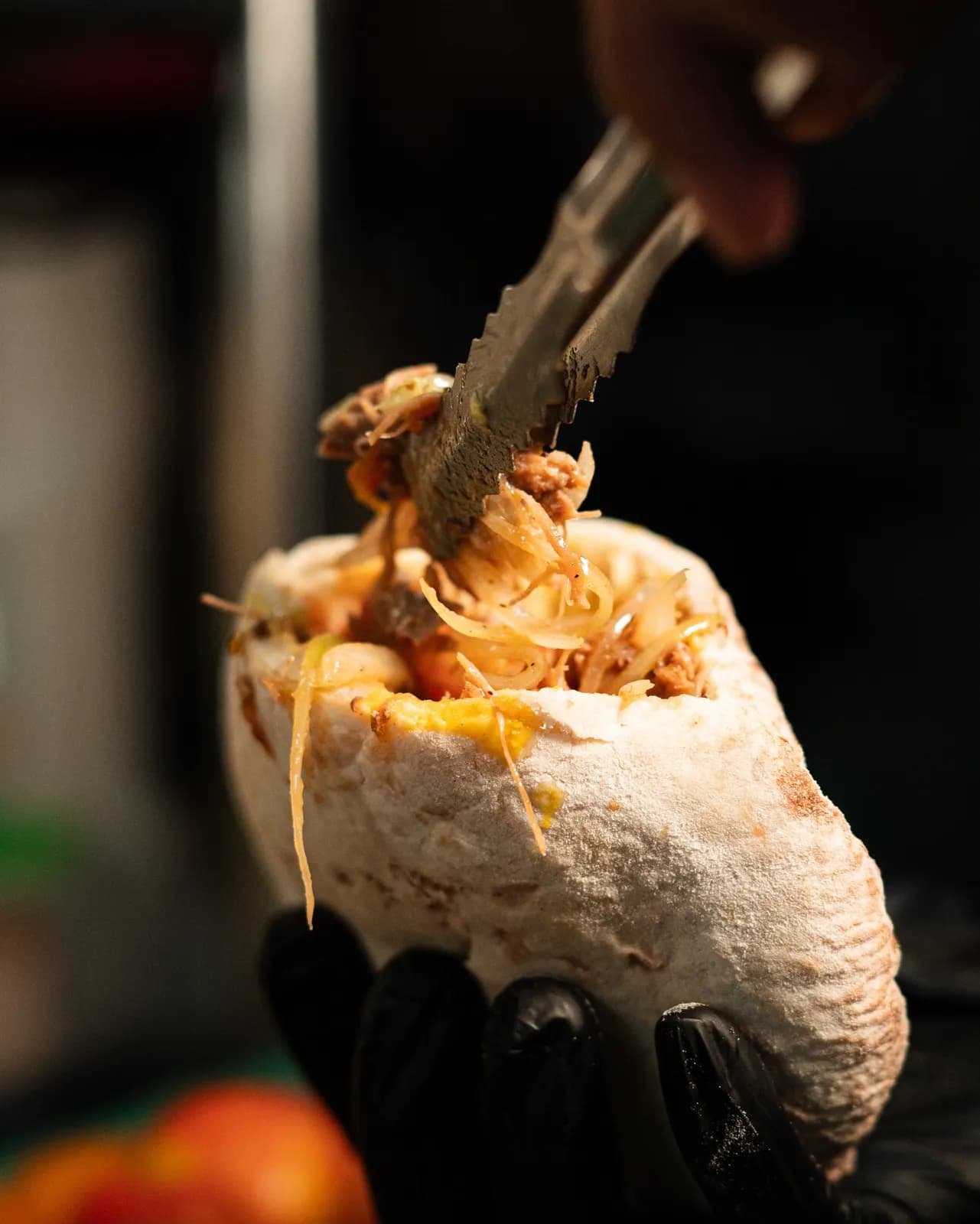 Shawarma bake in pita bread held above the table