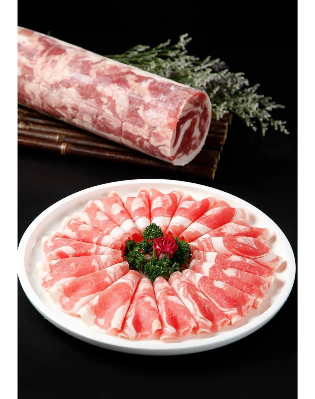 Plates of thinly sliced lamb with herbs