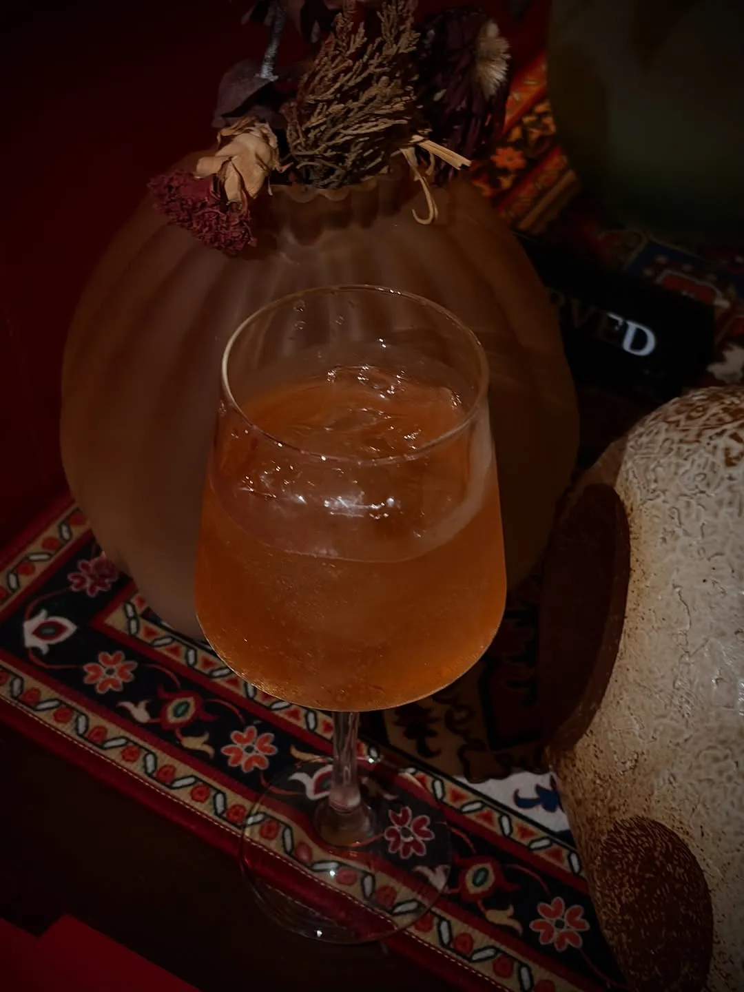 Pink Parisian Paloma cocktail on a patterned rug