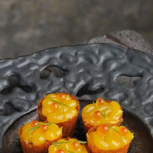 Five crisp rice cups topped with a bright yellow filling