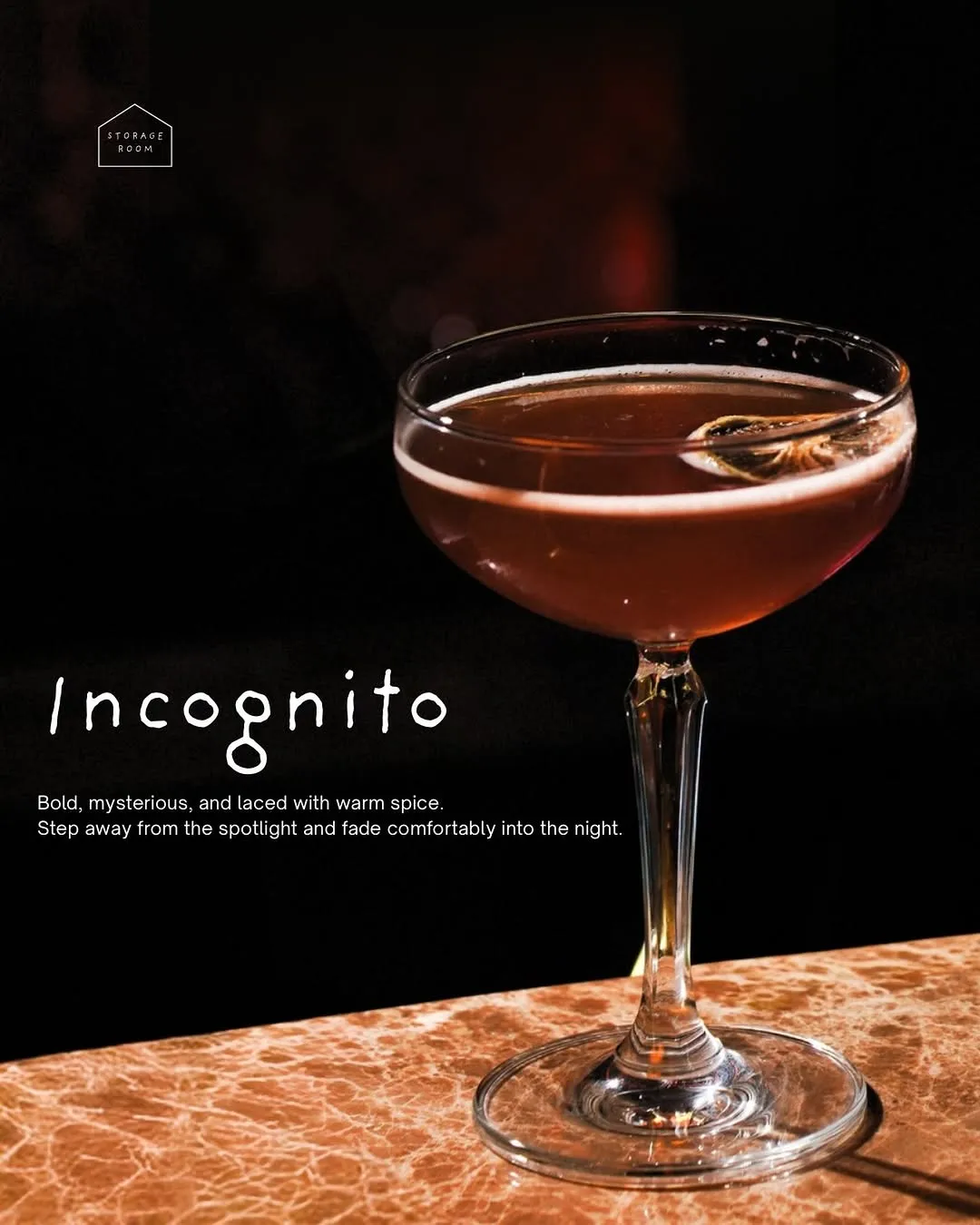 Dark red cocktail in a coupe on the bar