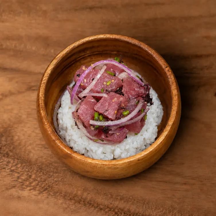 OG Limu tuna poke over rice in a wooden bowl