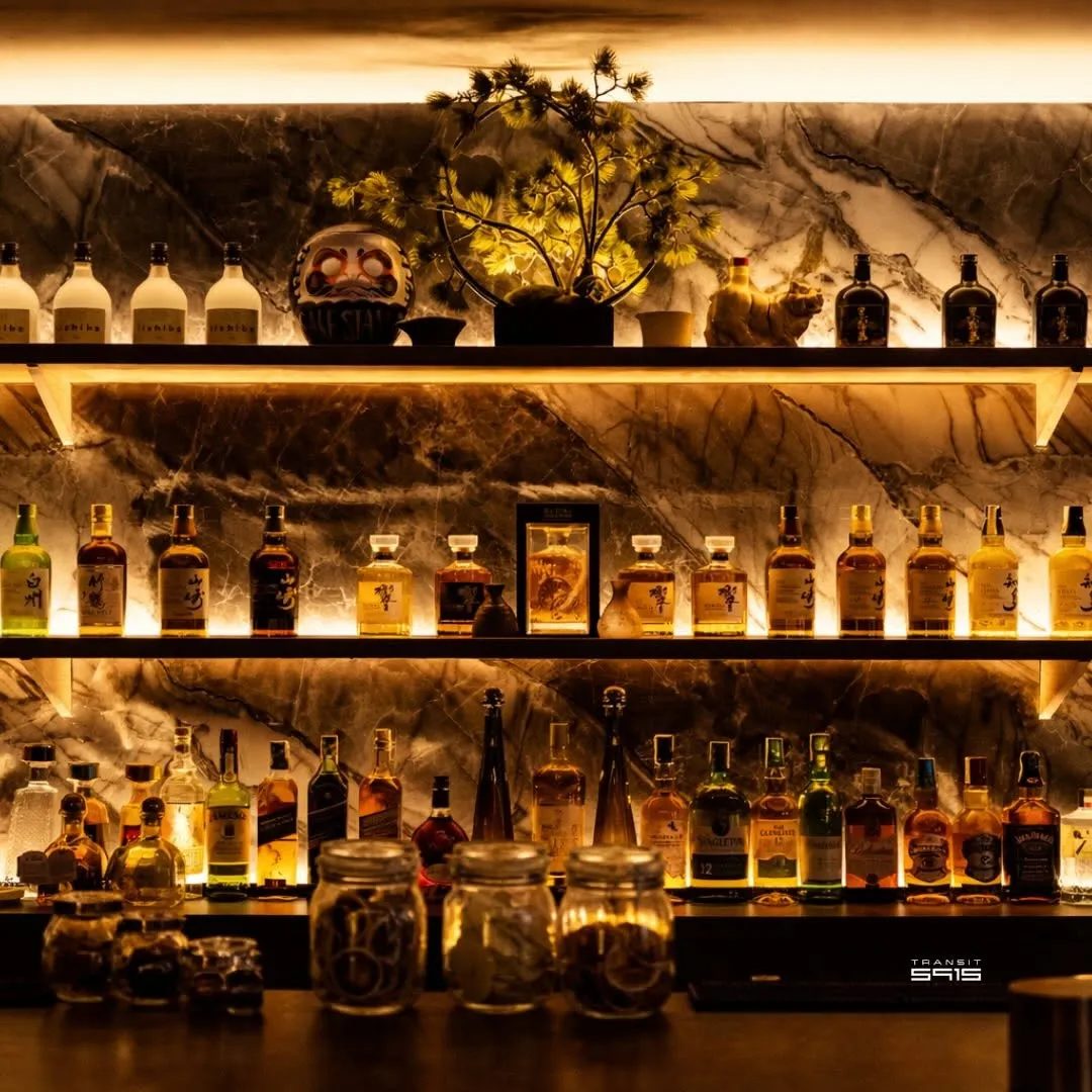 Backlit shelves of Japanese whisky behind the bar
