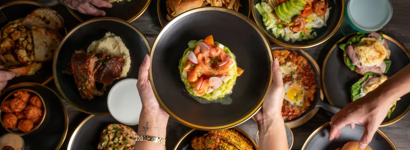 Overhead table spread of eggs, ribs, salad and other cafe dishes
