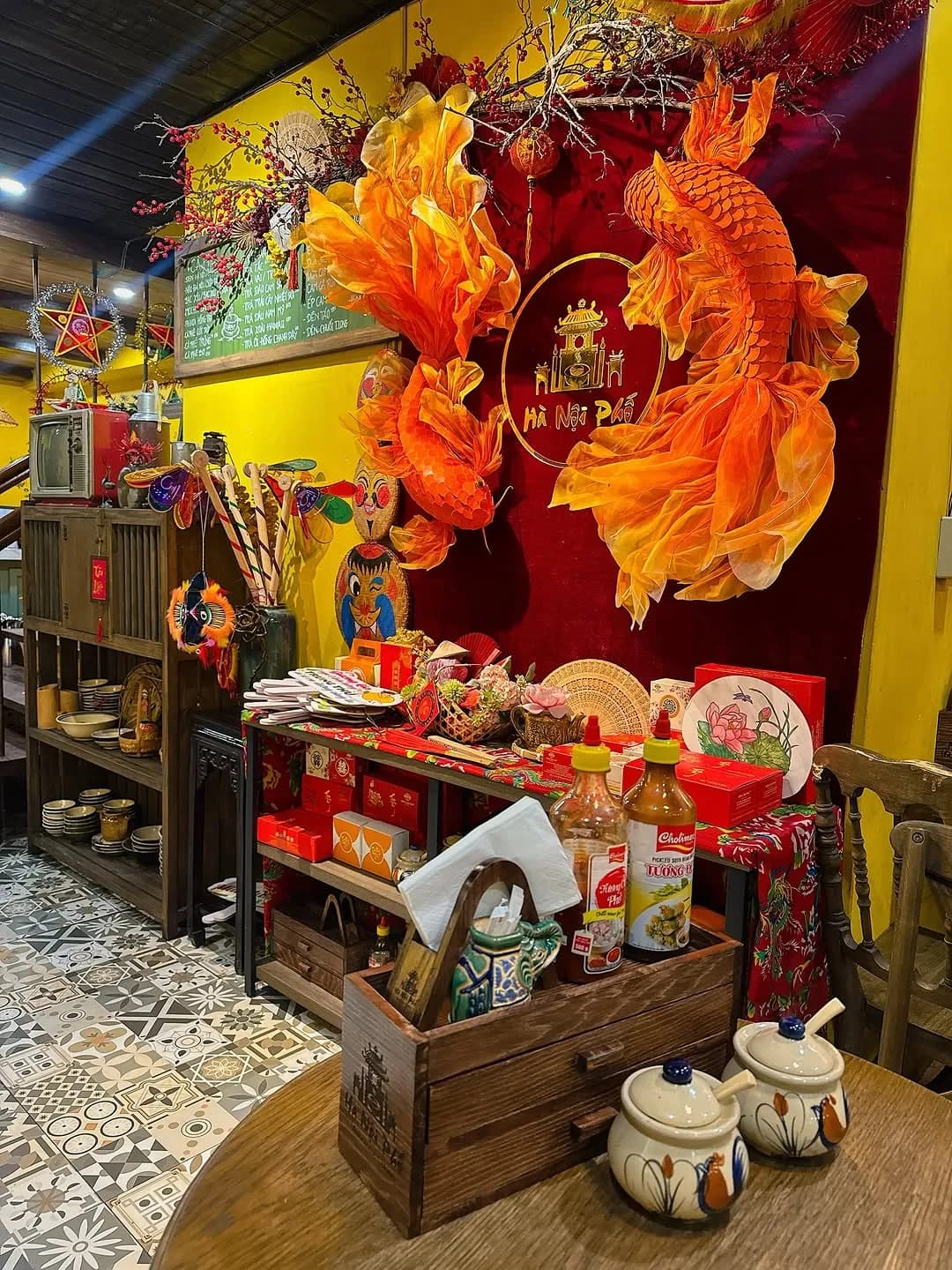 Restaurant corner with Vietnamese ornaments and an orange dragon display